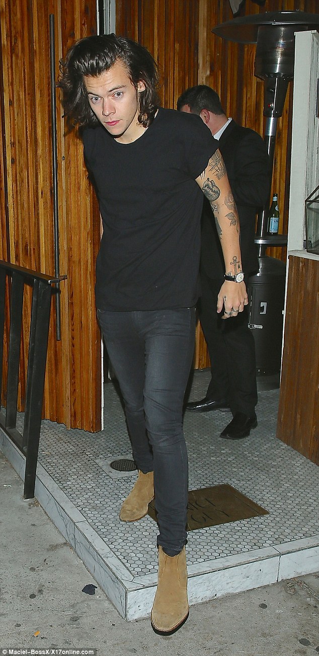 Ink-mad: Harry's short sleeved T-shirt offered a glimpse of his heavily tattooed arms 