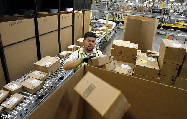 Delivery: Amazon workers in Phoenix worked hard to sort packages for delivery in this file photo from November 11, 2010, with holiday sales online building each consecutive year