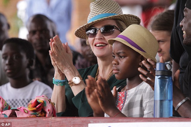 'Betrayal': The grandparents of Mercy James, pictured in the straw hat with Madonna, have accused the star of reneging on a promise to let them see her