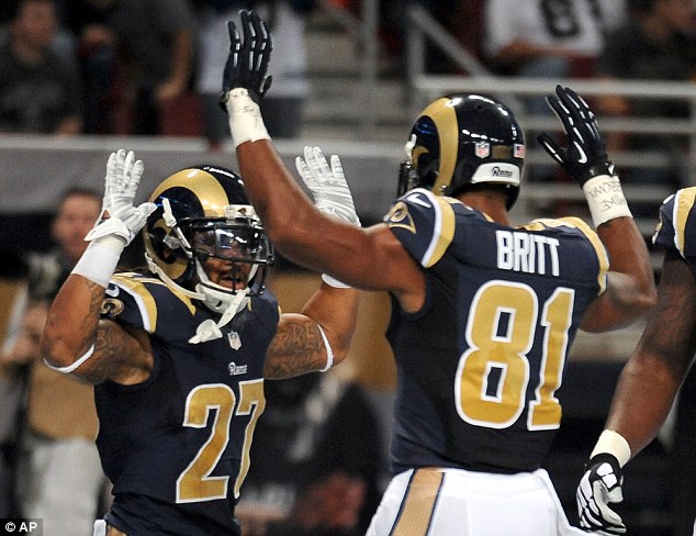 Symbolic: The gesture - a reference to witness accounts of Michael Brown's fatal shooting on August 9, also made another appearance after  Mason (left) scored a touchdown and was congratulated by Britt (right)