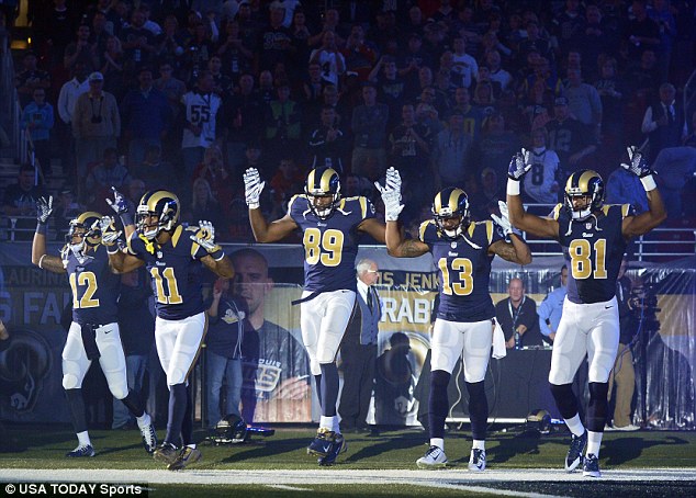 Solidarity: St. Louis Rams wide receiver Stedman Bailey (12), wide receiver Tavon Austin (11), tight end Jared Cook (89), wide receiver Chris Givens (13) and wide receiver Kenny Britt (81) put their hands up to show support for Michael Brown before Sunday's game against the Oakland Raiders at the Edward Jones Dome