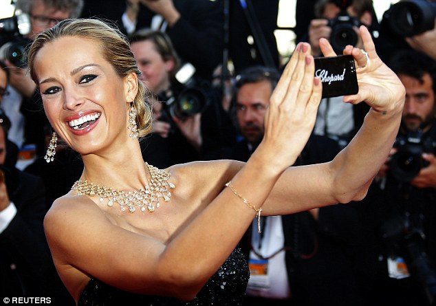 Model Petra Nemcova takes a selfie as she poses on the red carpet at the Cannes Film Festival in May