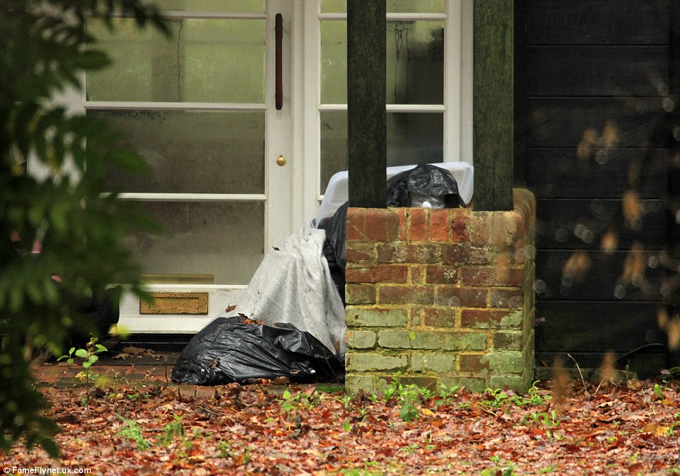 Leaves and weeds cover the driveway, and rubbish bags sit next to the front door. The house is reportedly empty after Mr Cohen moved out with his two children