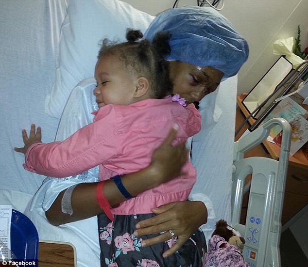Thankful: But speaking at her home in O'Fallon, St Louis, on Monday, she said she is simply thankful to have survived the shooting. Above, Miss Conner is pictured hugging one of her two young daughters in hospital