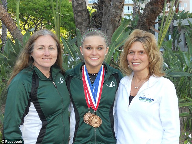 Winner: Brooke poses with her coaches after taking home a triple haul of medals after a gymnastics meet
