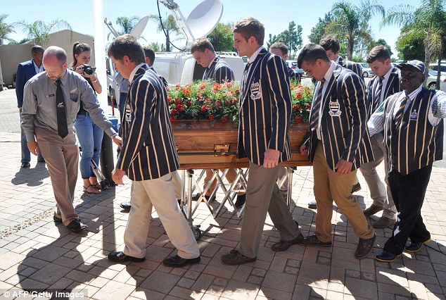 Pupils from the Grey College School carry the casket of Pierre Korkie into the church during the service