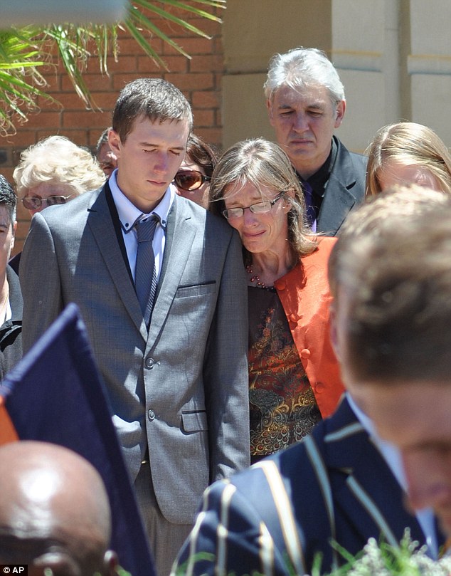 Pierre's wife Yolande Korkie and their son Pieter-Ben follow the coffin at the funeral service