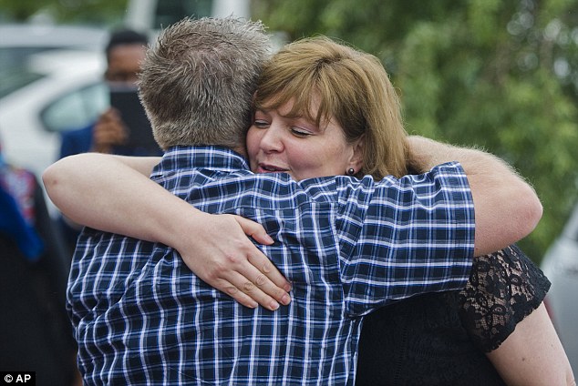 Hannelie Groenewald, the wife of slain Werner Groenwald, is comforted after a memorial service in Pretoria