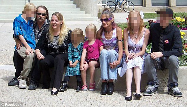 Matriarch: McCabe (third left) has three biological children and two stepdaughters (all are pictured here with their faces obscured)