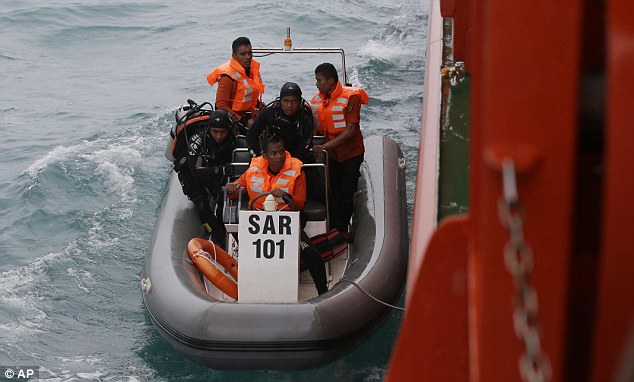 Fully-equipped divers and other agency members board the rescue boat and make their way out to sea
