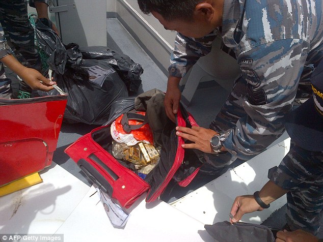 A backpack containing cigarettes and other personal effects is brought on board the KRI Bung Tomo