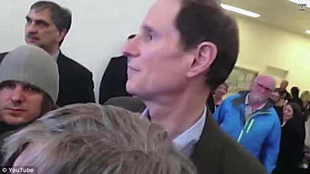 BEFUDDLED: An annoyed Sen. Wyden stood and watched as his event disintegrated at the hands of protesters whose politics he shares
