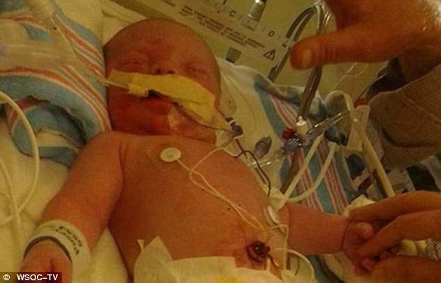 Saved: Riley Andrew Williams was delivered by c-section on Tuesday morning after his mother was killed when she collided with another vehicle. He was saved after troopers performed CPR on his mother's body