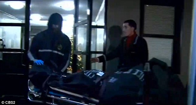 Gruesome: Above, investigators remove Thomas Gilbert Sr's body from his apartment building on Manhattan's Upper East Side