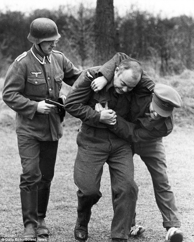 A 'prisoner' is taken back to the camp, where guests paid £30 to live the life of a prisoner of war for a weekend, at gunpoint by a German soldier after trying to escape