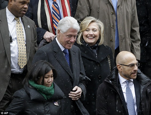 Frosty entrance? Though Hillary Clinton has been accused of 'storming' into a church on Tuesday, she was seen smiling and with her arm wrapped around her husband's while leaving 