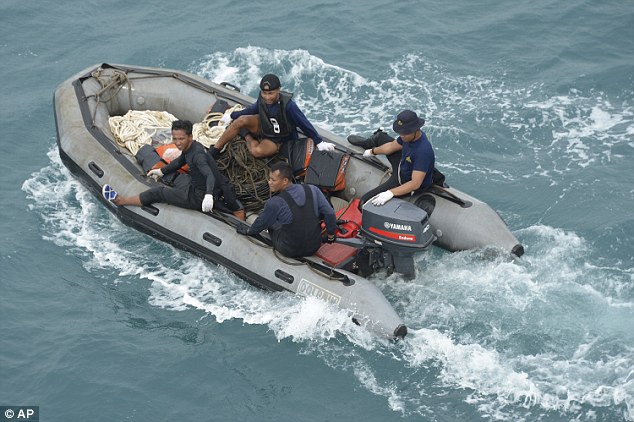 Divers travelled by rubber boat from the KRI Banda Aceh warship that was being stationed close to the site of tail wreckage