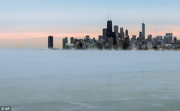 Steam rises over Lake Michigan near the Chicago skyline on Thursday. Dangerously cold air has sent temperatures plummeting into the single digits around the U.S., with wind chills driving them even lower