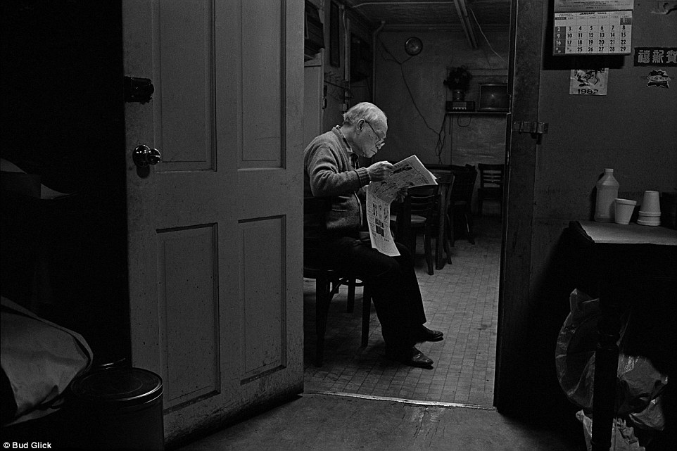 News: A man reads in his apartment in 1982