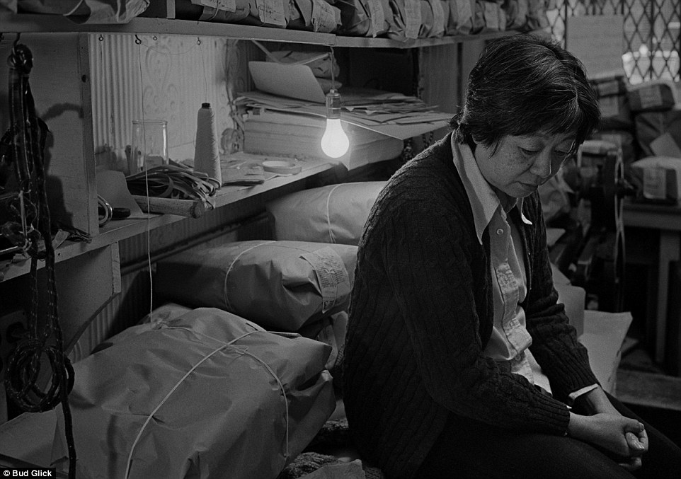 Rest: A woman has a break from her work in a laundry