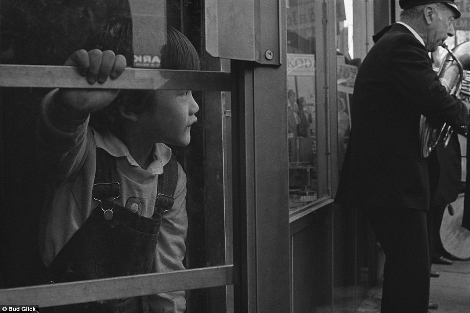 Quick peek: A child looks out to the street from a shop on Division St in 1992