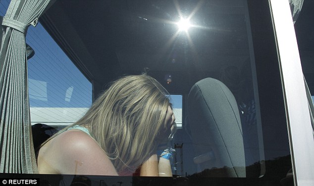 Devastated: One of the passenger puts her head in her heads as she waits to go back to hotel 