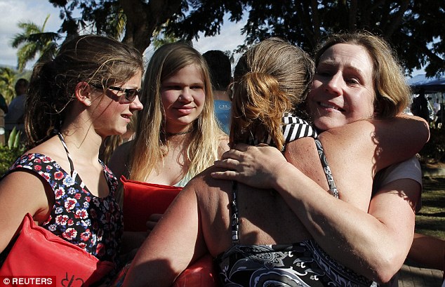 Tragedy: Tourists who survived a shipwreck off the  coast of Costa Rica, are received by relatives in Herradura beach, Puntarenas. Three people including an elderly American and Canadian woman died