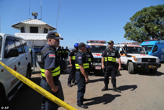 Emergency response: Costa Rican police and paramedics await the arrival of tourists who were rescued