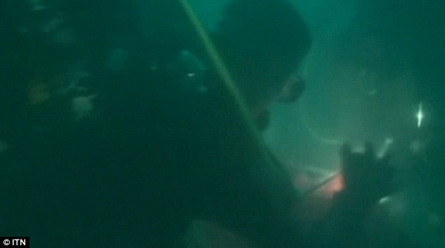 New footage has emerged showing Indonesian military divers investigating the tail of AirAsia flight 8501