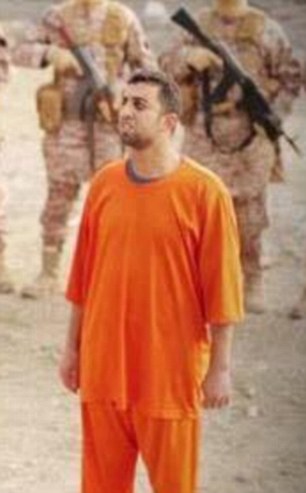 Moaz al-Kasasbeh pictured moments before he is locked in the cage where he is burned to death