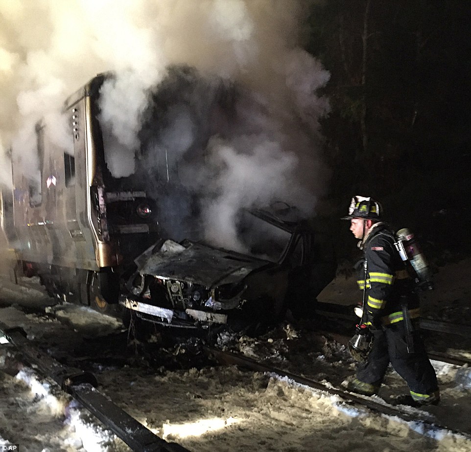 The train, running northbound on the Harlem line, smashed into the black Jeep Cherokee  as it was traveling through Valhalla in Westchester County on Tuesday. Above, the Jeep, which was pushed around 150 yards up the tracks, is pictured underneath the train