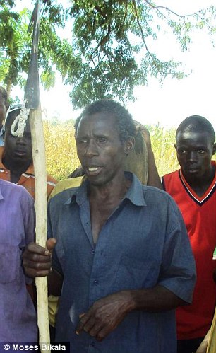 Local hero: Mubarak Batambuze, 50, who slew a 25t, 1,300lb crocodile after it ate his pregnant wife while she was out fetching water at Lake Kyoga