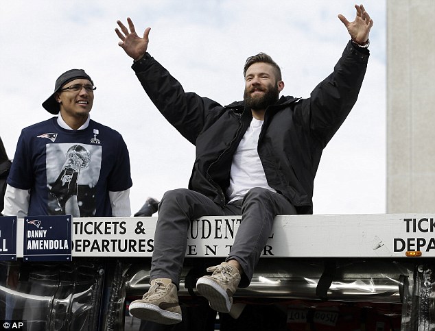 Julian Edelman acknowledges cheers from the crowd gathered for the New England Patriot's Superbowl parade on Wednesday. A woman has now posted a photo of the player sleeping next to her in bed