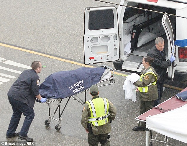 The body of Kim Howe is wheeled away by the LA coroner's office in Los Angeles, America on February 7 after Bruce Jenner was involved in the smash in his Cadillac Escalade