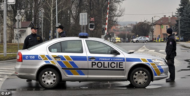 Police officers stand guard near to where a gunman opened fire. They closed roads in the area surrounding the scene 