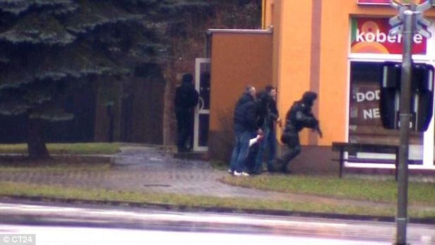 Police secure the restaurant in the eastern Czech town of Uhersky Brod, where eight people have been shot dead 